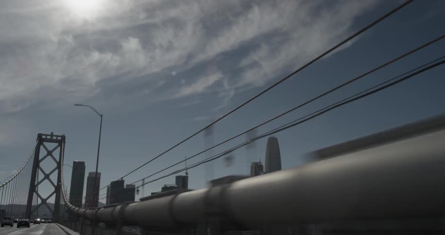 The city zooms by as a car drives along the highway