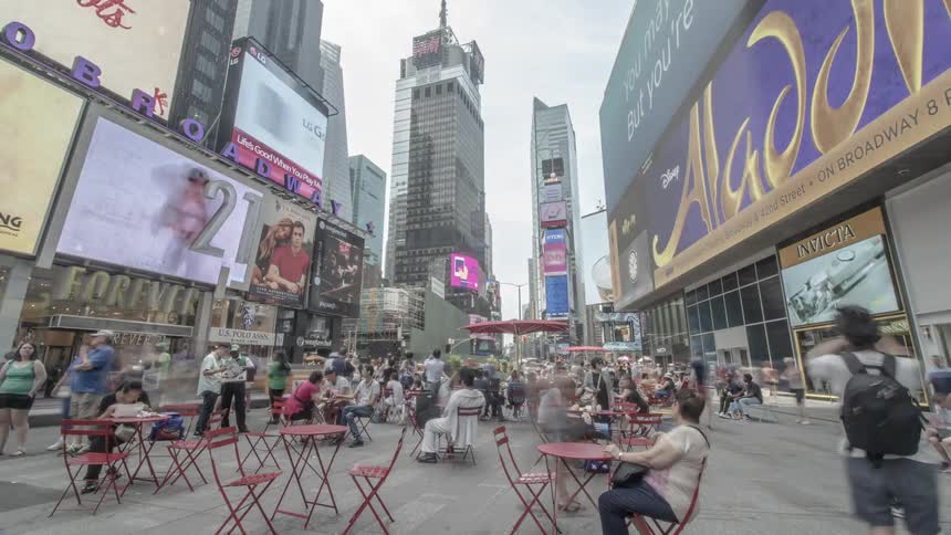 Hundreds of people site seeing and eating lunch in a very crowded street