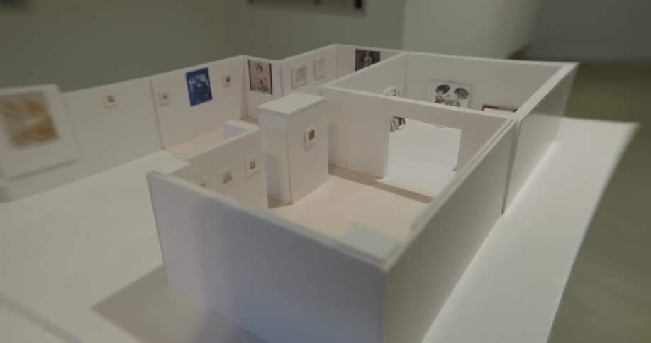 An architectural model is displayed on a table
