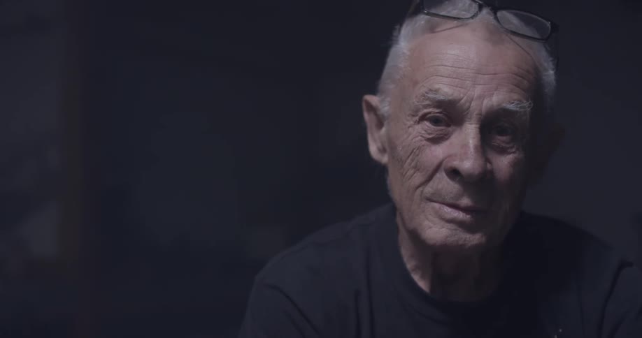 A man sitting in a dark room