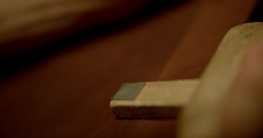 A person working on a piece of suede