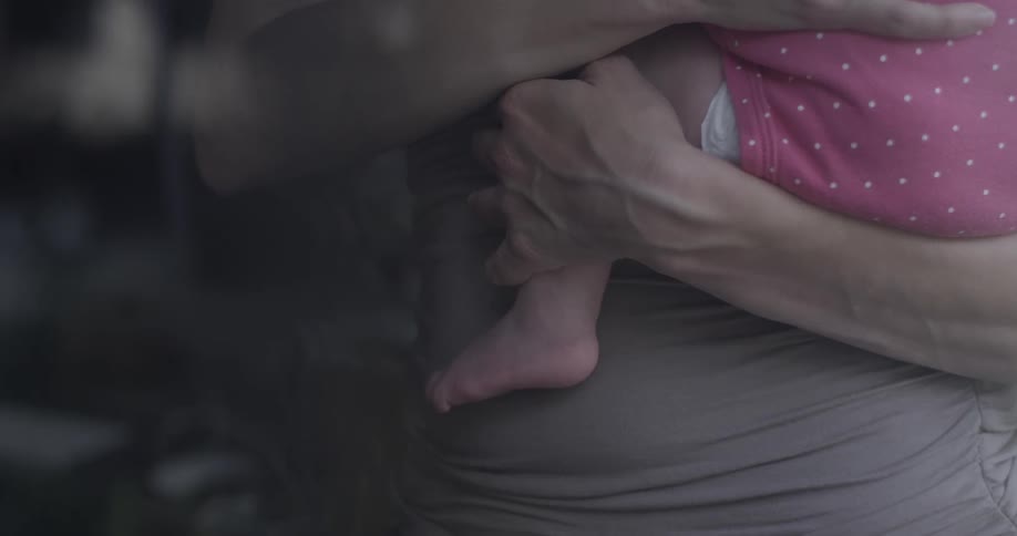 A woman holds a baby