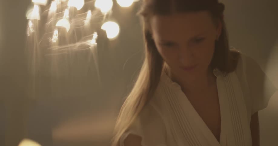 Woman in white sets a table