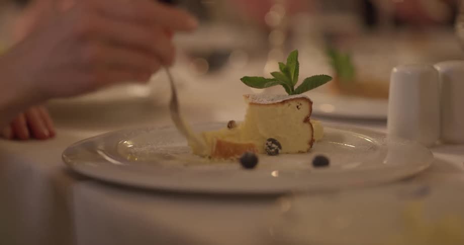 A person is taking a bite of cake