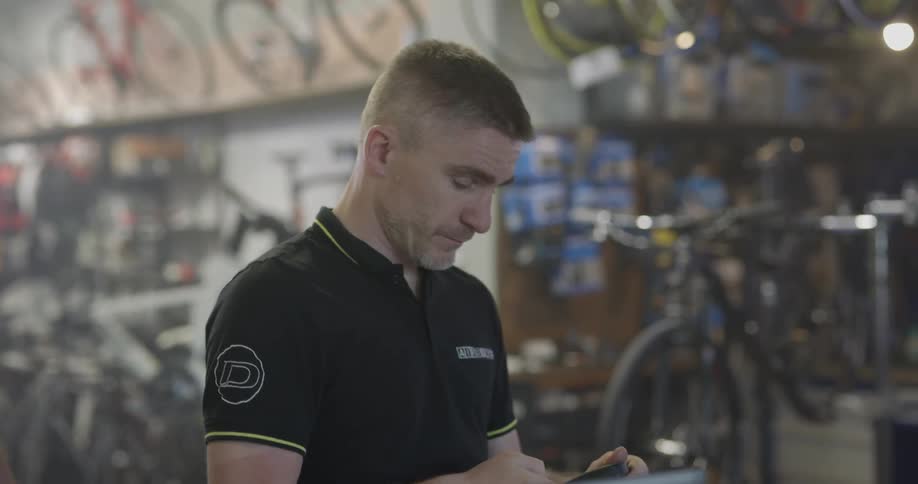 Man looks over inventory inside bike shop