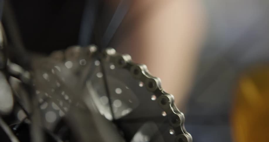 A man spinning a bicycle tire in a repair shop