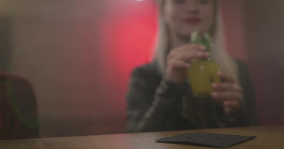 Bartender serves woman a drink