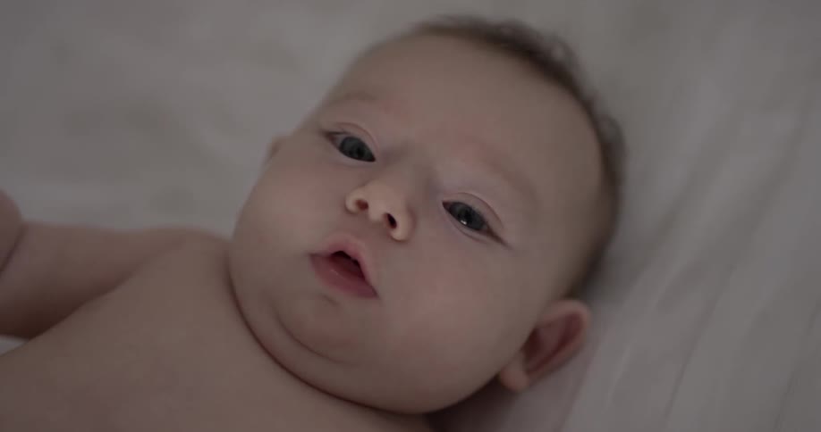 Baby looks up and wiggles around