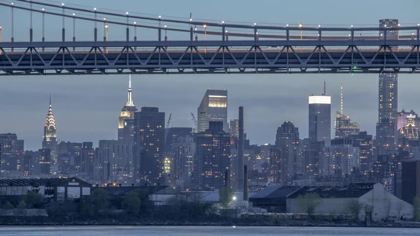 Cars move across a city bridge