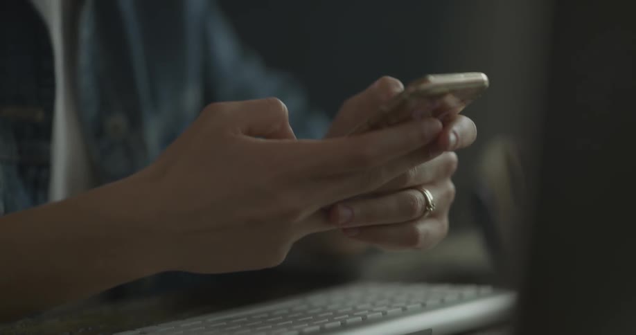 Woman texts on her photo while sitting in front of a keyboard