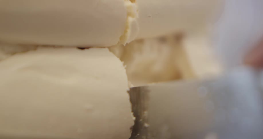 Cake is being cut with a knife