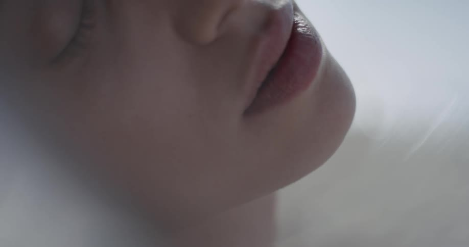 Woman leans her head back
