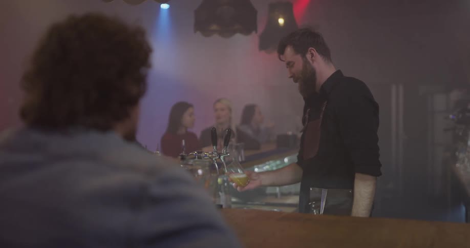 Man orders a beer at a bar