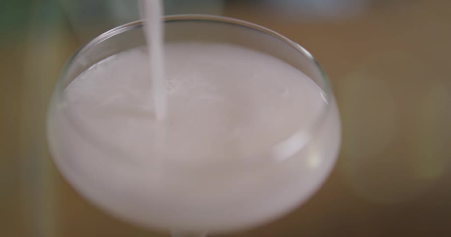 Liquid is being poured into a glass