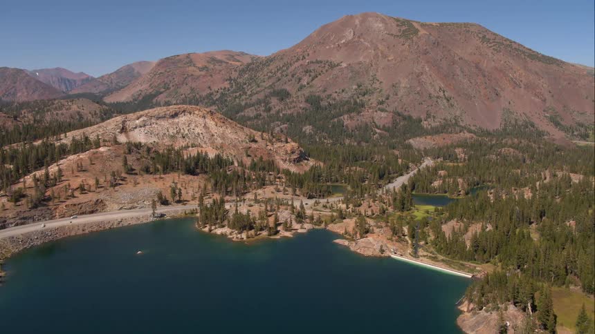 Lake next to tree covered mountains