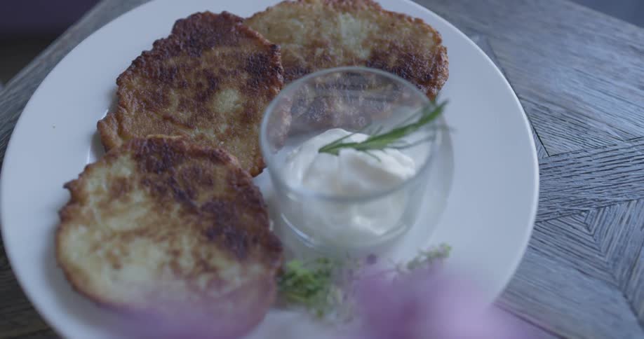 A person setting a plate down on a table