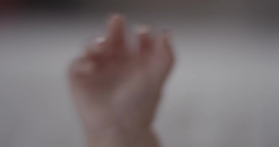 A baby's hand slowly opens
