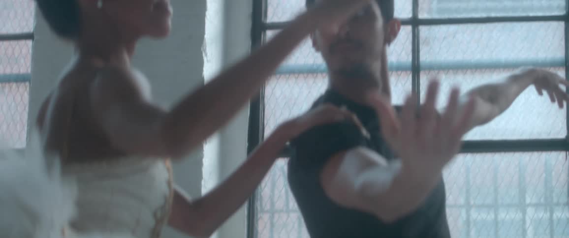 Man helps a woman practice ballet