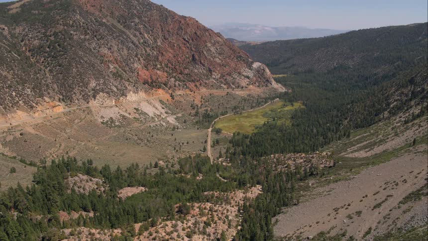Road cuts through mountain valley