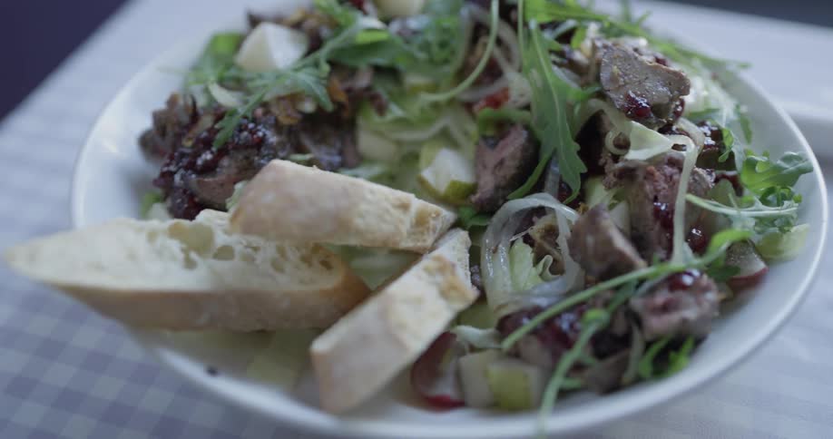 A plate of salad is placed down