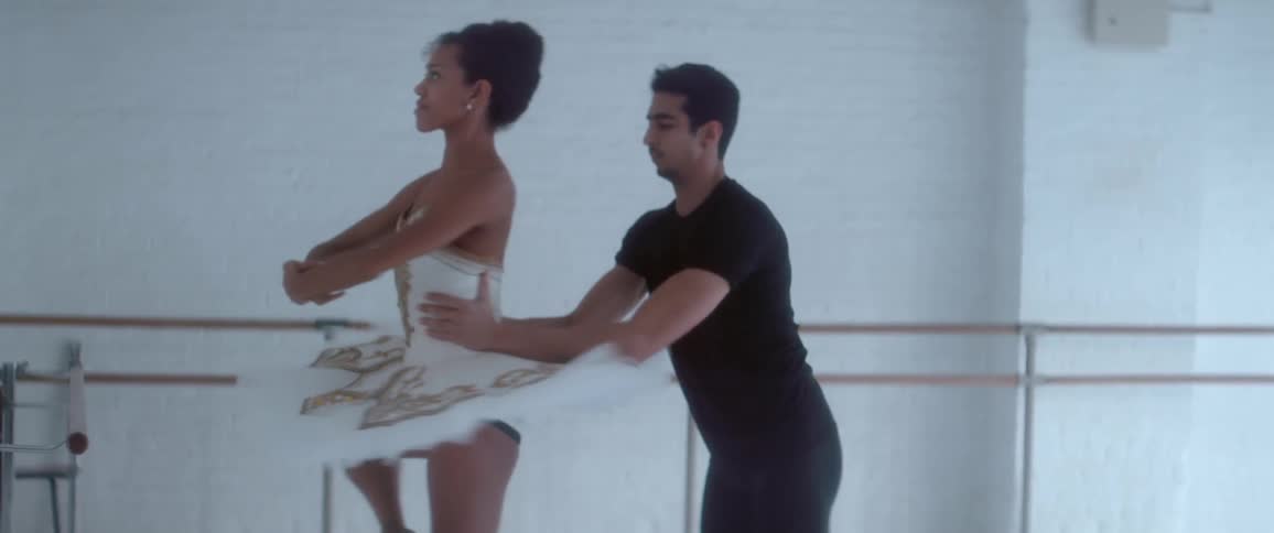 A man in black twirling a ballerina