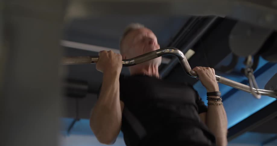A man is using work out equipment in a gym
