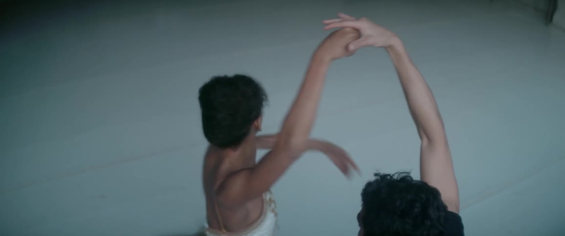 Man helps a woman practice ballet