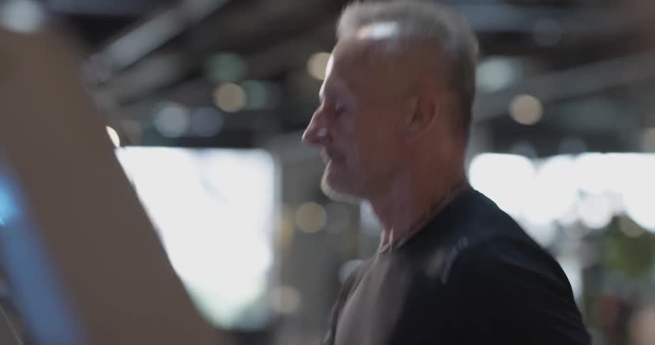 A man running on a treadmill in a gym