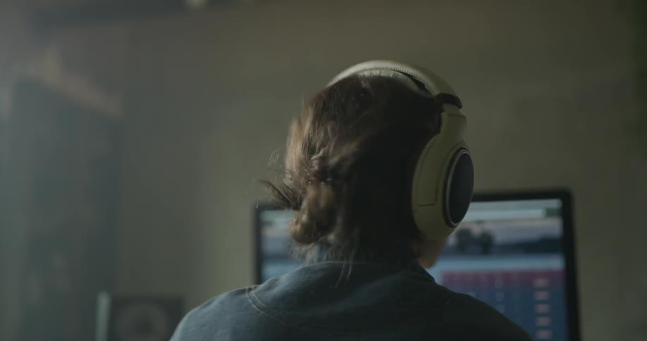Woman wearing headphones nods to music