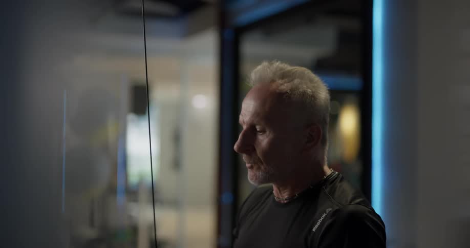 A man is using work out equipment in a gym