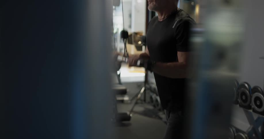 Man working his arm muscles on an exercise machine