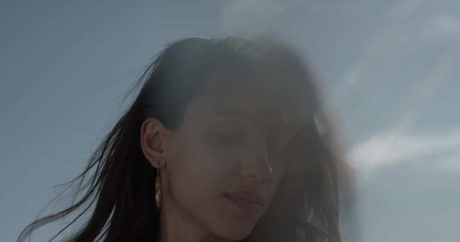 A woman's hair is blown in the breeze
