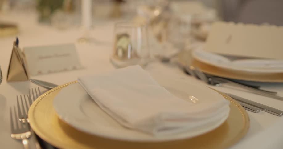 There are plates, napkins, and utensils on the table