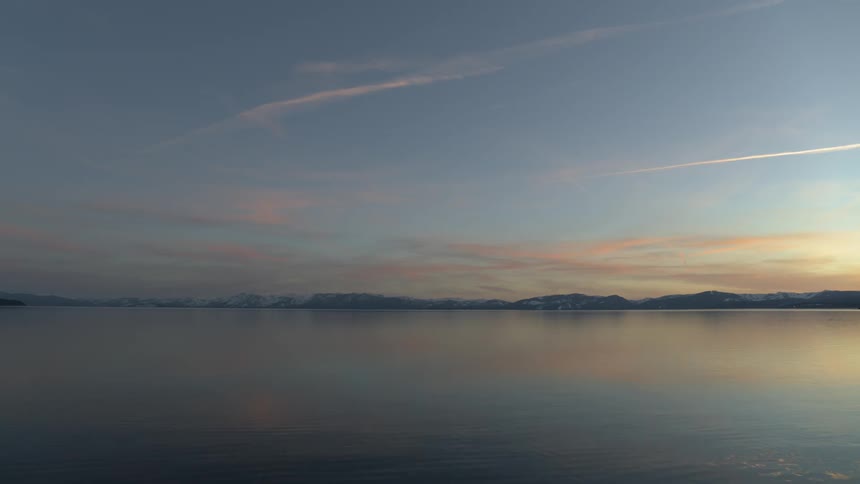 A large lake at the edge of a mountain range