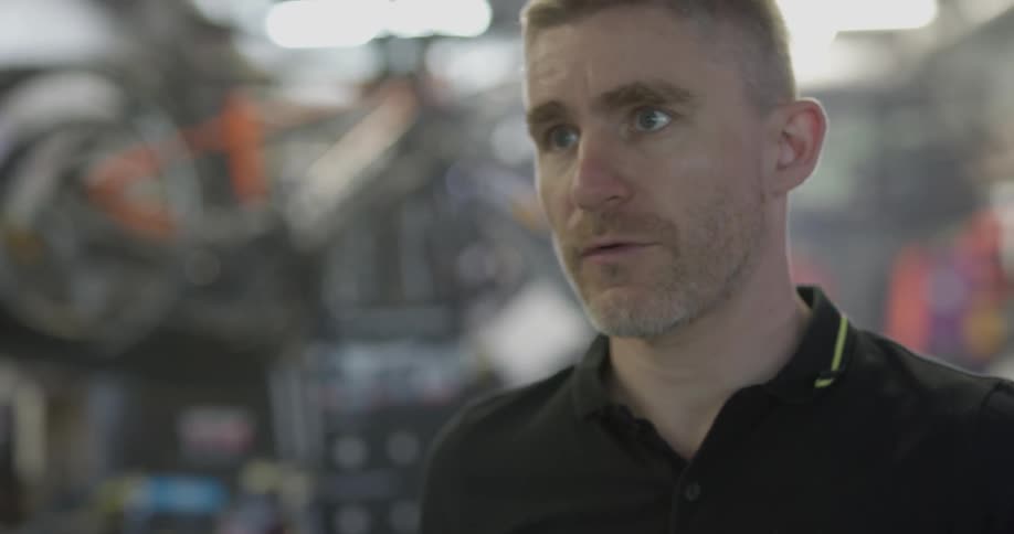 A bicycle shop employee works in the shop