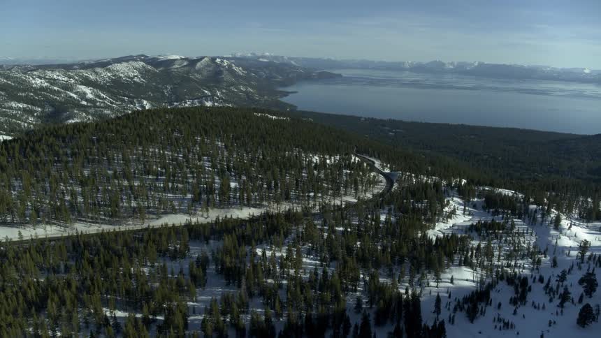 Snow and trees are covering the mountains