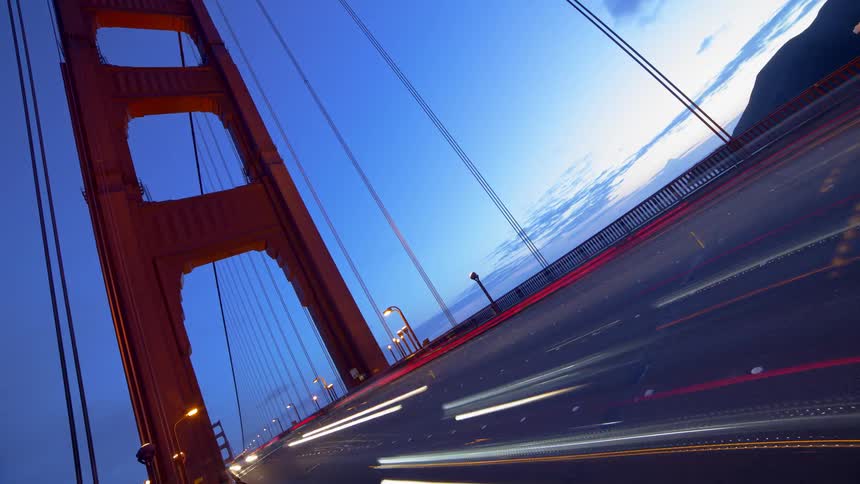 People are driving cars on a bridge