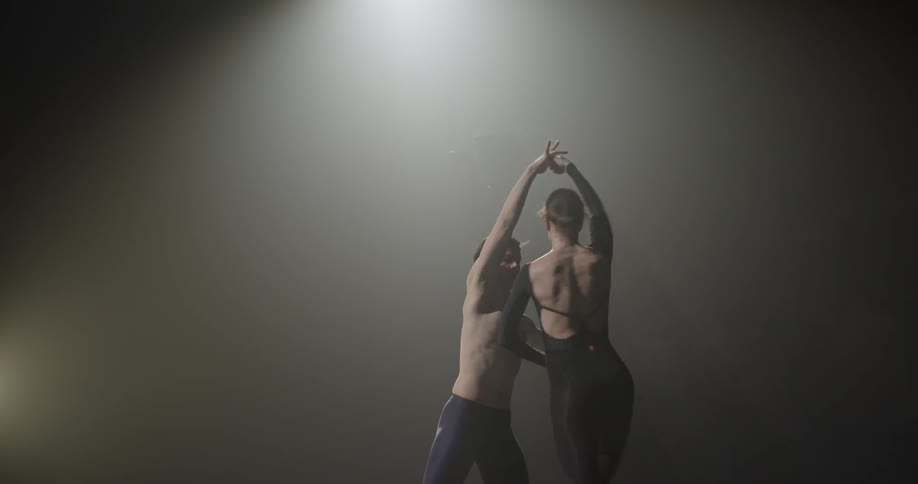 A man spins a woman several times as they dance together
