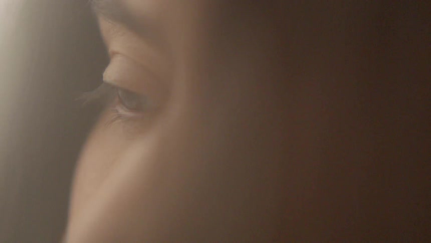 A woman opens her eyes