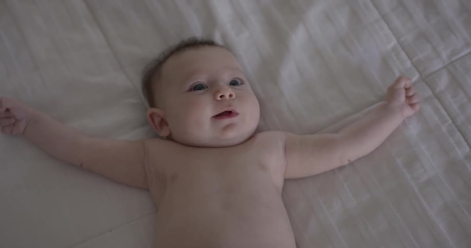 Baby smiles as he looks up