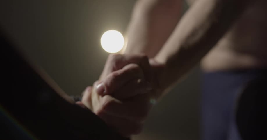 Two people lock hands together and lift up