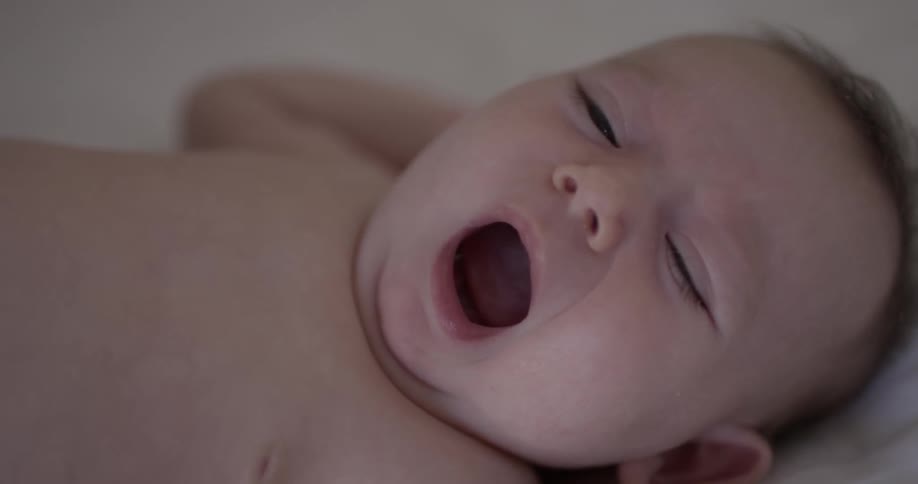 A small infant yawning