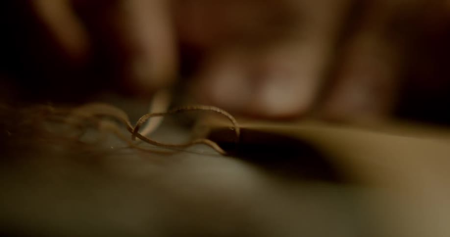 A person is using a tool to cut an object
