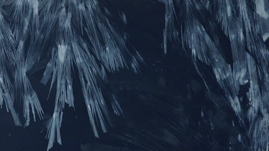 Ice crystals form on a flat surface