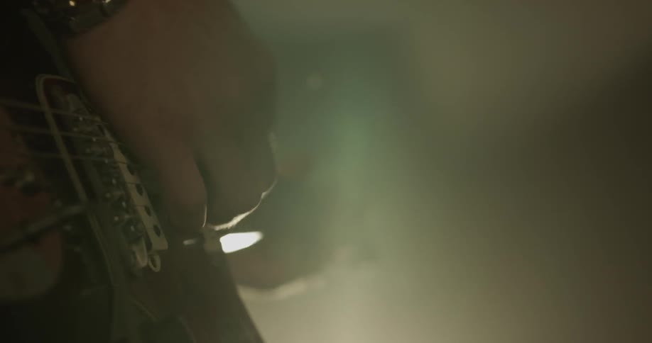 Closeup of man playing a guitar