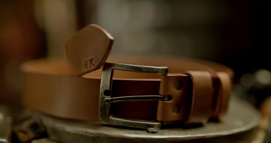 A leather belt sits on the counter