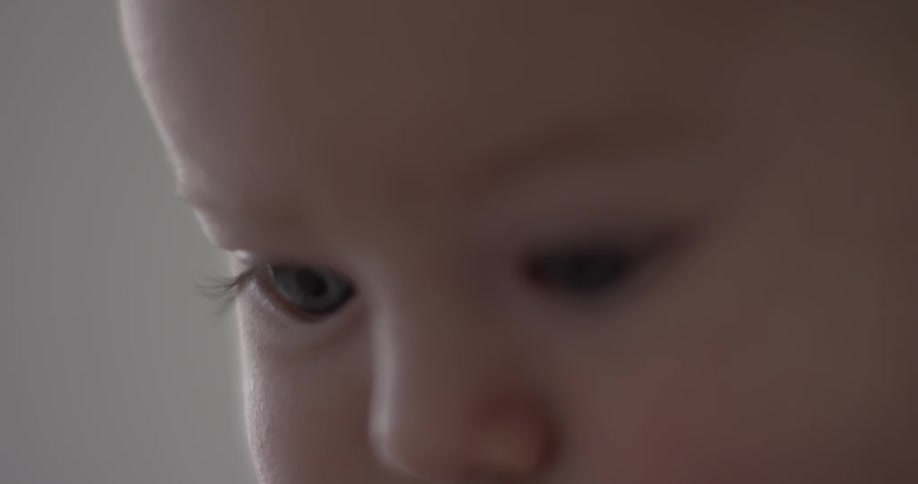 A baby stares at something out of view