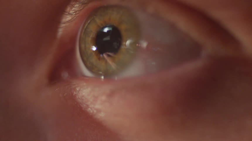 A person looks up and their pupil dilates
