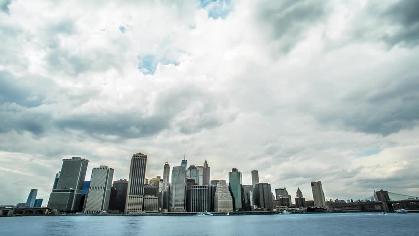 Boats cross the water in front of a city skyline