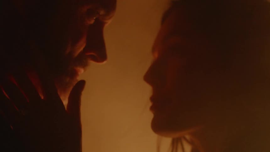 Couple Kissing By Fire In Desert